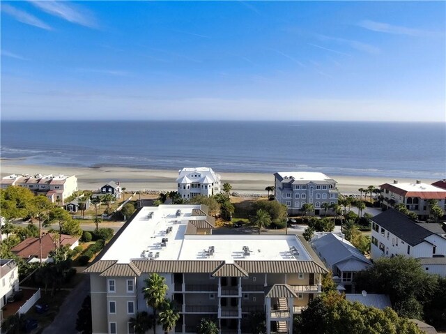 drone / aerial view with a water view and a beach view