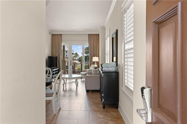 hall featuring dark tile patterned floors and ornamental molding