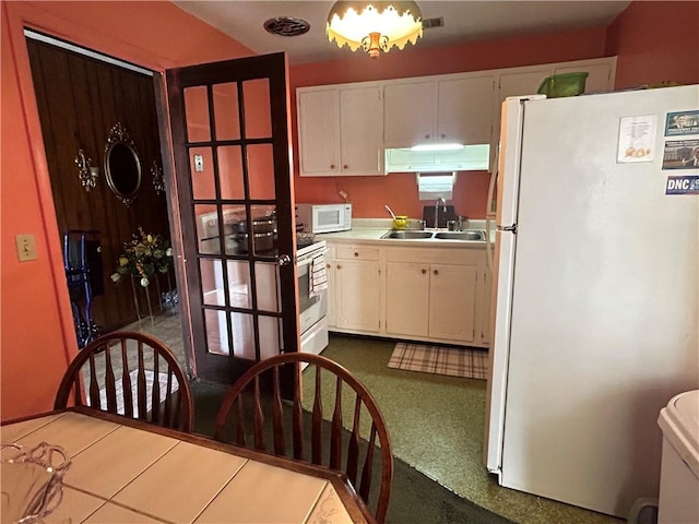 kitchen with white cabinetry, white appliances, and sink