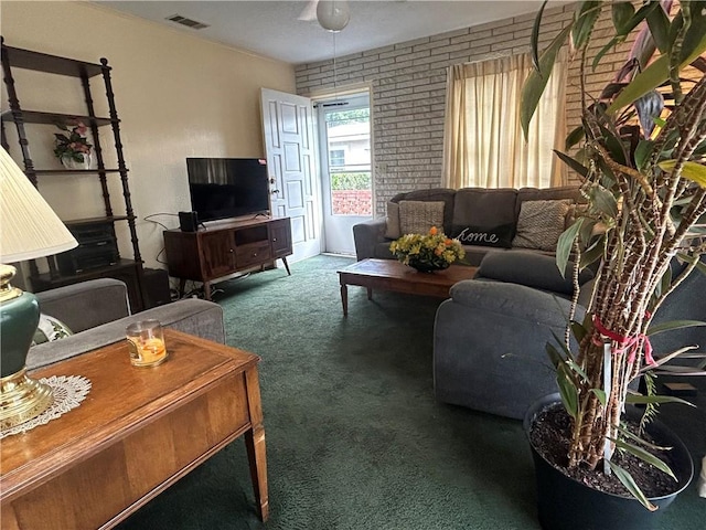 living room featuring carpet floors and brick wall