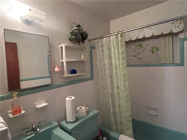 bathroom with sink, shower / bathtub combination with curtain, and tile walls