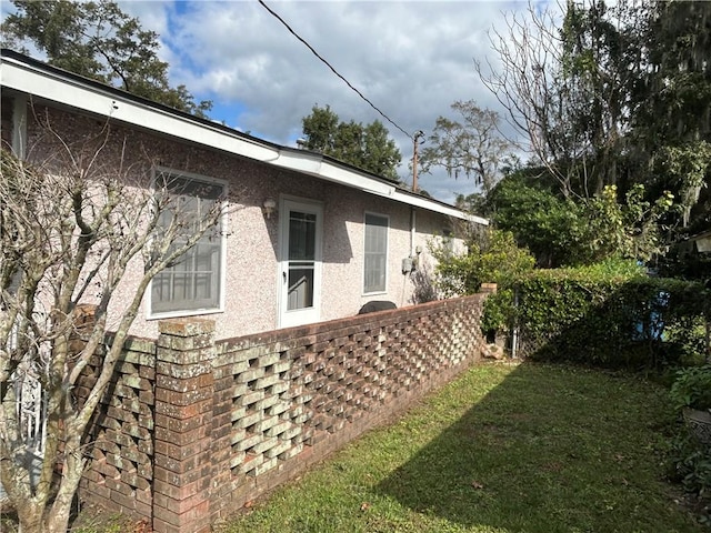 view of side of home featuring a yard