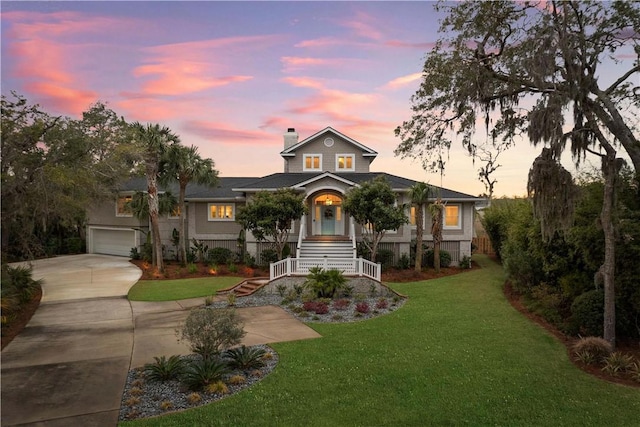 view of front of home with a garage, concrete driveway, stairway, a chimney, and a front yard