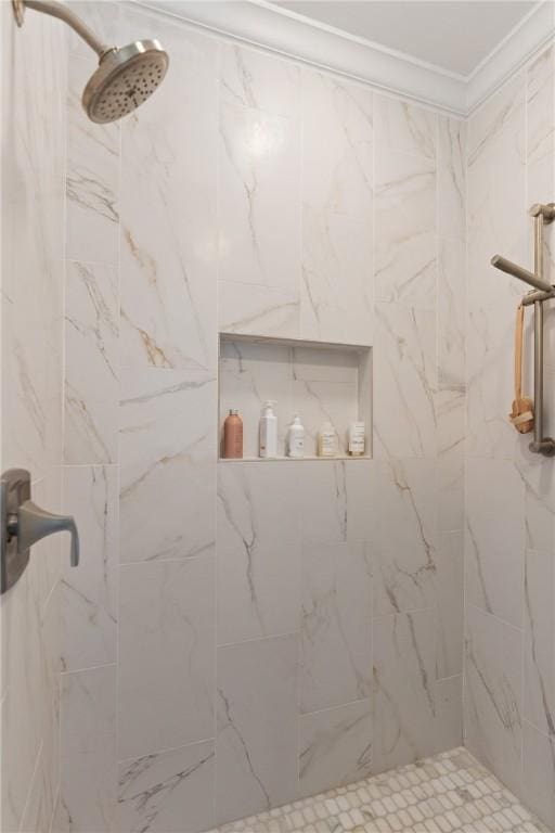 bathroom featuring a marble finish shower and crown molding