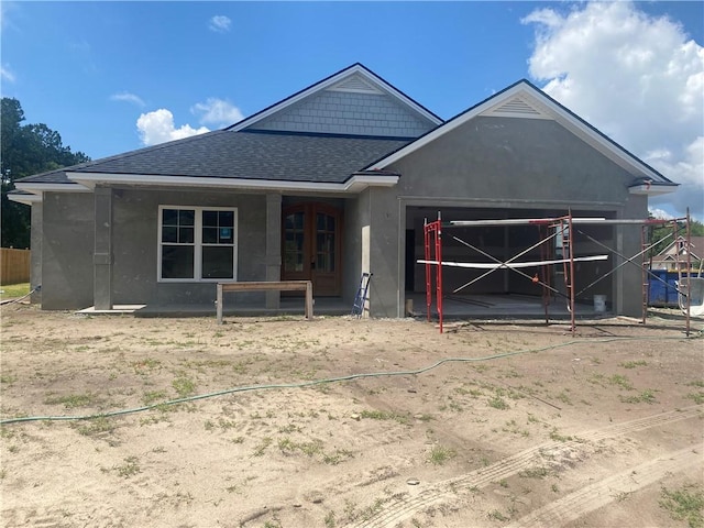 217 Sweetwater Blvd, Brunswick, GA 31525 - view of front of home featuring a shingled roof, a garage, and stucco siding
