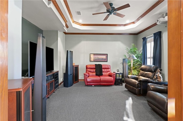 carpeted living room with crown molding, ceiling fan, and a tray ceiling