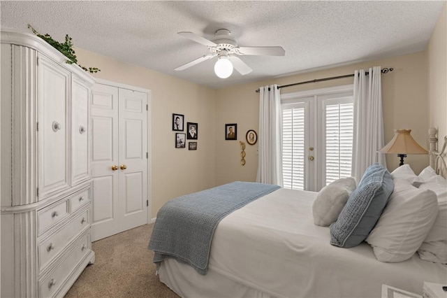 bedroom with ceiling fan, light colored carpet, a textured ceiling, and access to outside