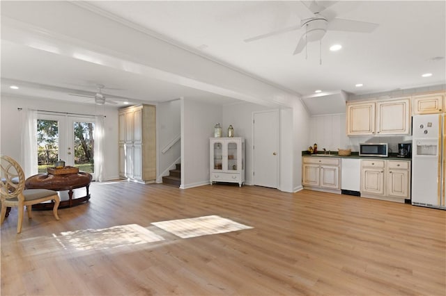 kitchen with french doors, white refrigerator with ice dispenser, cream cabinets, and light wood-type flooring