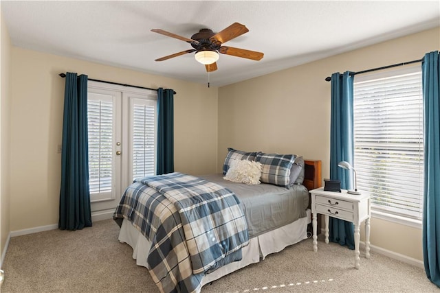 carpeted bedroom featuring ceiling fan and multiple windows