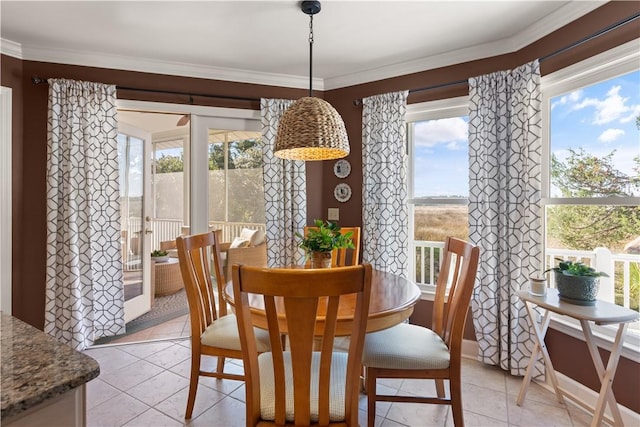 dining space featuring crown molding and light tile patterned flooring