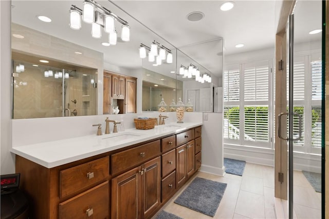 bathroom with tile patterned floors, vanity, and a shower with door