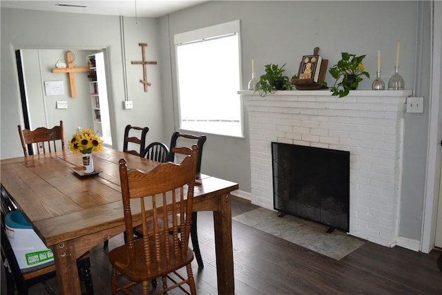 1308 Dean Dr, Waycross, GA 31501 - dining area featuring wood finished floors and a brick fireplace