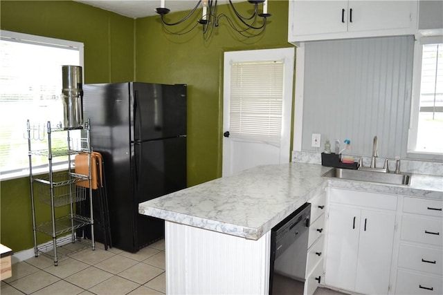 1308 Dean Dr, Waycross, GA 31501 - kitchen featuring freestanding refrigerator, dishwasher, light countertops, light tile patterned flooring, and white cabinetry