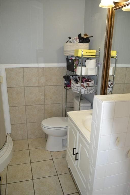 1308 Dean Dr, Waycross, GA 31501 - bathroom featuring tile patterned floors, tile walls, vanity, and wainscoting