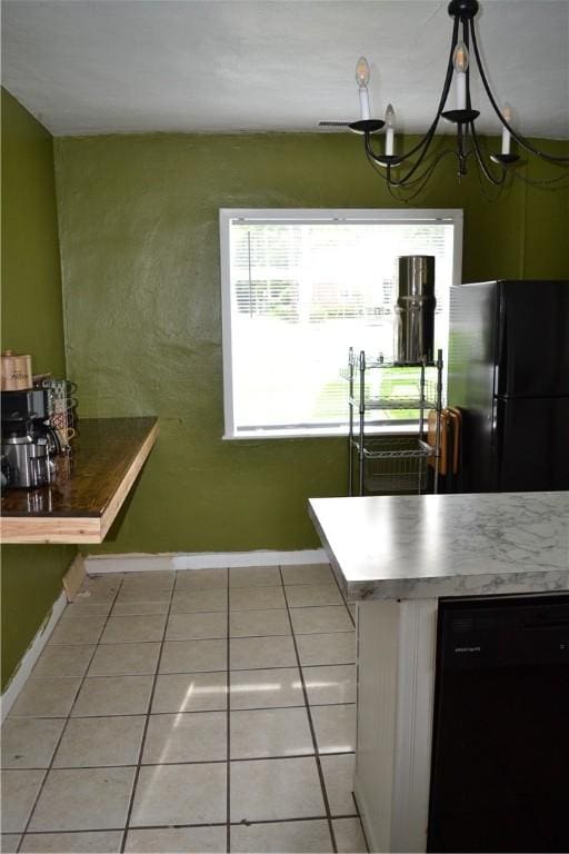 1308 Dean Dr, Waycross, GA 31501 - kitchen with black appliances, light tile patterned floors, a chandelier, and pendant lighting