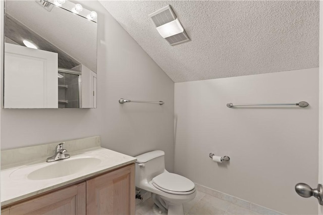 bathroom featuring a textured ceiling, vanity, lofted ceiling, and toilet