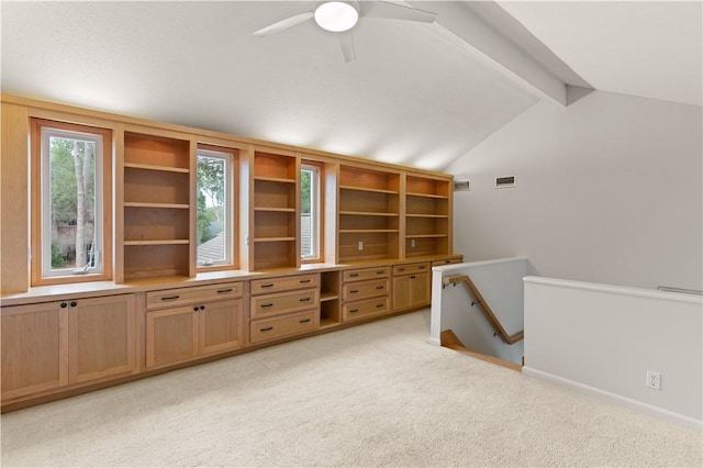 interior space featuring light carpet, ceiling fan, and lofted ceiling with beams