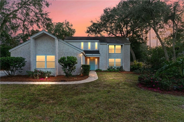 view of front of property with a lawn