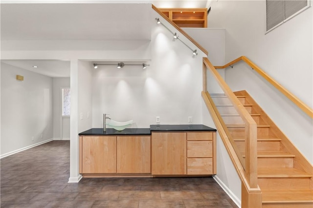 bar with light brown cabinetry