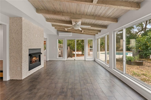 unfurnished sunroom with ceiling fan, vaulted ceiling with beams, a wall mounted AC, and wood ceiling