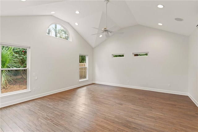 empty room with ceiling fan, high vaulted ceiling, and dark wood-type flooring