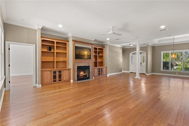 unfurnished living room with decorative columns, light hardwood / wood-style flooring, and ceiling fan