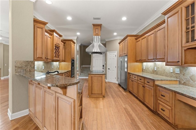 kitchen featuring light stone counters, kitchen peninsula, appliances with stainless steel finishes, and light hardwood / wood-style flooring