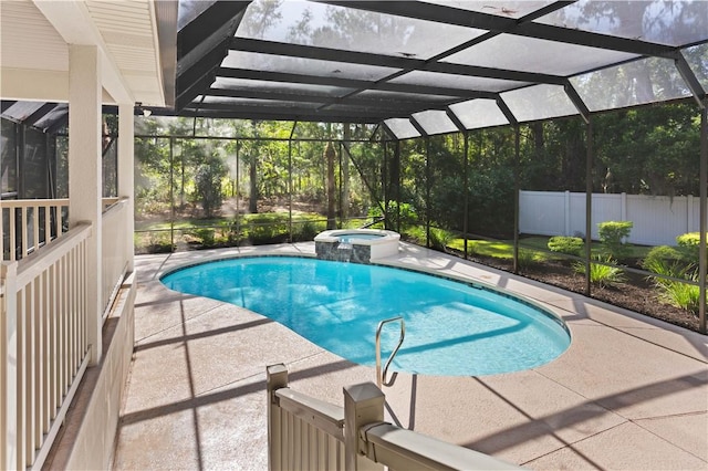 view of swimming pool with a lanai, an in ground hot tub, and a patio