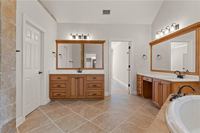 bathroom with tile patterned floors, a tub to relax in, vanity, and lofted ceiling