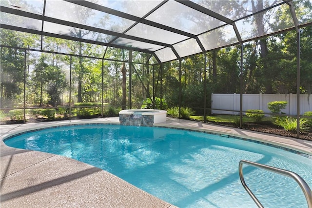 view of swimming pool featuring an in ground hot tub and glass enclosure