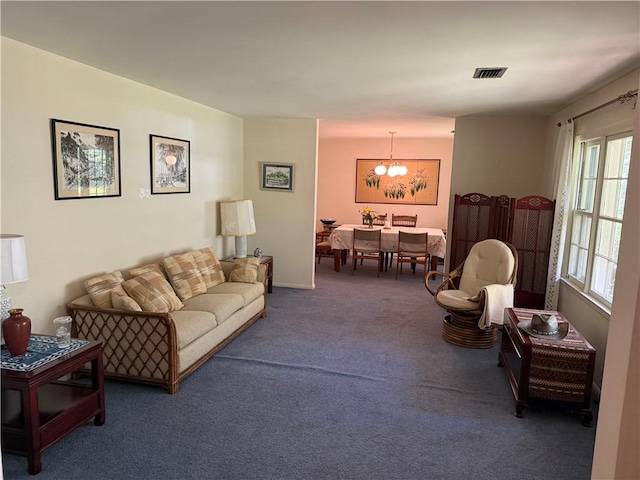 411 Whitefield Ave, Saint Simons Island, GA 31522 - carpeted living area with a chandelier