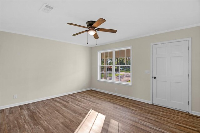 unfurnished room featuring wood finished floors, ceiling fan, baseboards, and visible vents