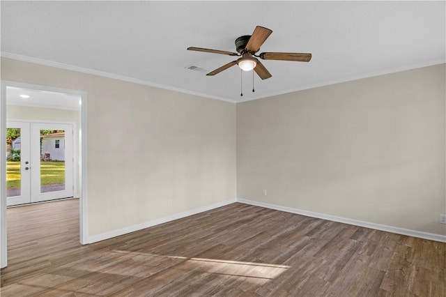 empty room featuring french doors, baseboards, visible vents, and wood finished floors