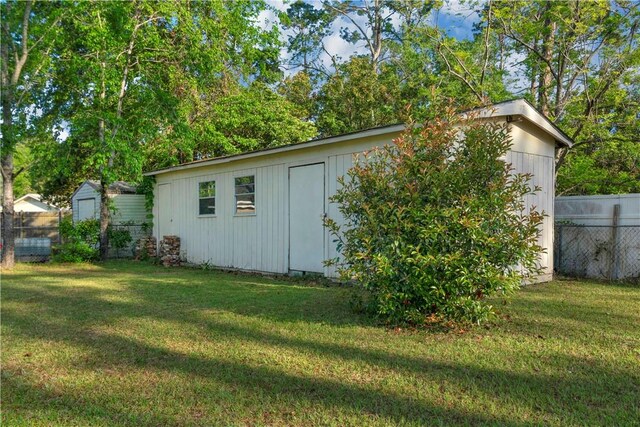 view of outbuilding with an outbuilding and fence