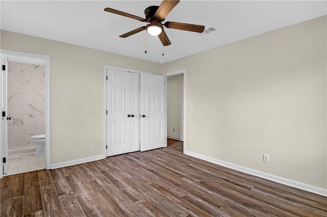 unfurnished bedroom with visible vents, baseboards, a closet, a ceiling fan, and wood finished floors
