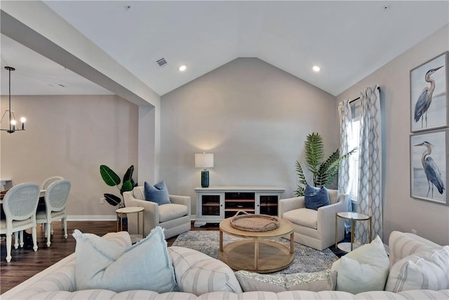 living room featuring a chandelier, wood-type flooring, and vaulted ceiling