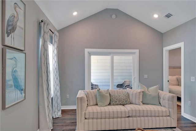 living room with lofted ceiling and dark wood-type flooring