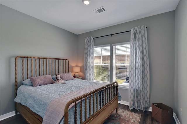 bedroom featuring dark wood-type flooring and multiple windows