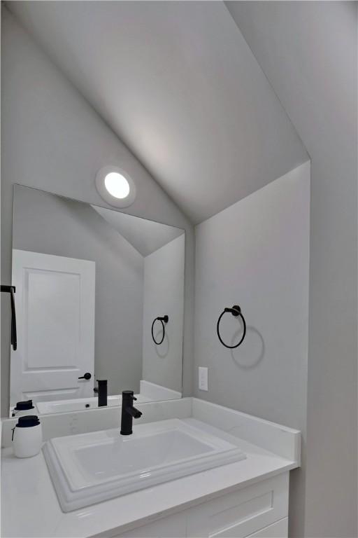 bathroom featuring vanity and vaulted ceiling