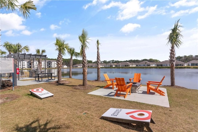 dock area featuring a lawn, a pergola, and a water view