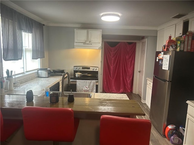 2627 Cleburne St, Brunswick, GA 31520 - kitchen with appliances with stainless steel finishes, white cabinetry, crown molding, wood finished floors, and a sink