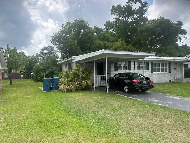 2627 Cleburne St, Brunswick, GA 31520 - view of front of house featuring asphalt driveway, a front yard, brick siding, and an attached carport