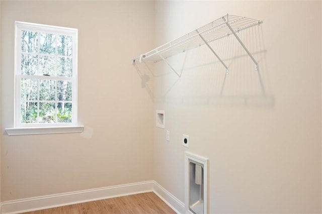 laundry area featuring washer hookup, light wood-style flooring, hookup for an electric dryer, laundry area, and baseboards