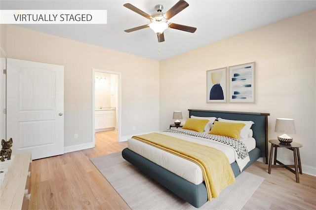 bedroom with ceiling fan, ensuite bath, baseboards, and wood finished floors