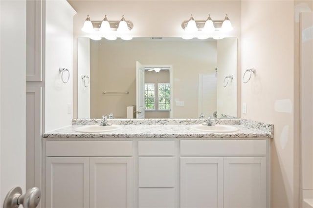 bathroom featuring double vanity and a sink