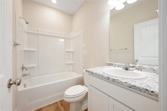 bathroom with wood finished floors, vanity, toilet, and shower / bathing tub combination