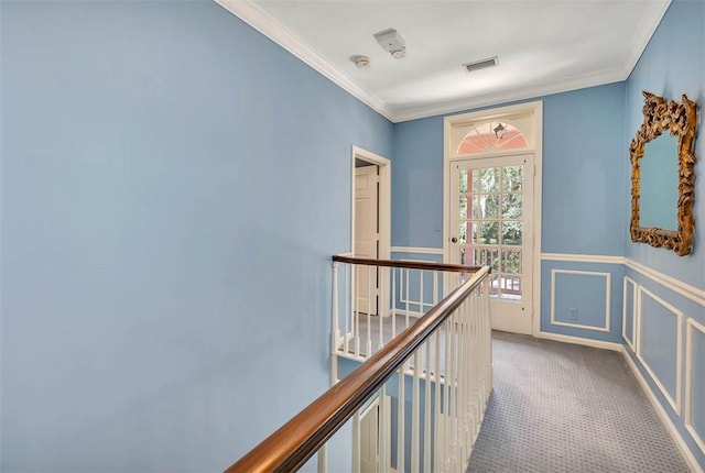 hallway with carpet flooring and ornamental molding