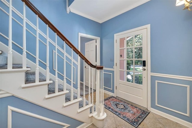 foyer entrance featuring ornamental molding