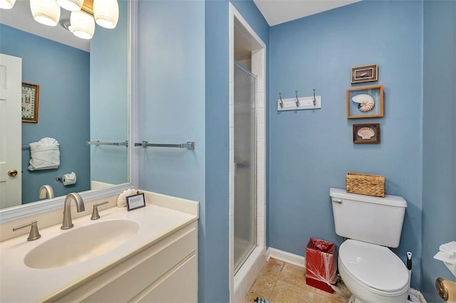 bathroom with toilet, an enclosed shower, and vanity