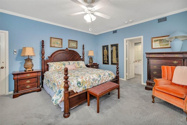 bedroom featuring light carpet, ensuite bath, ceiling fan, and ornamental molding